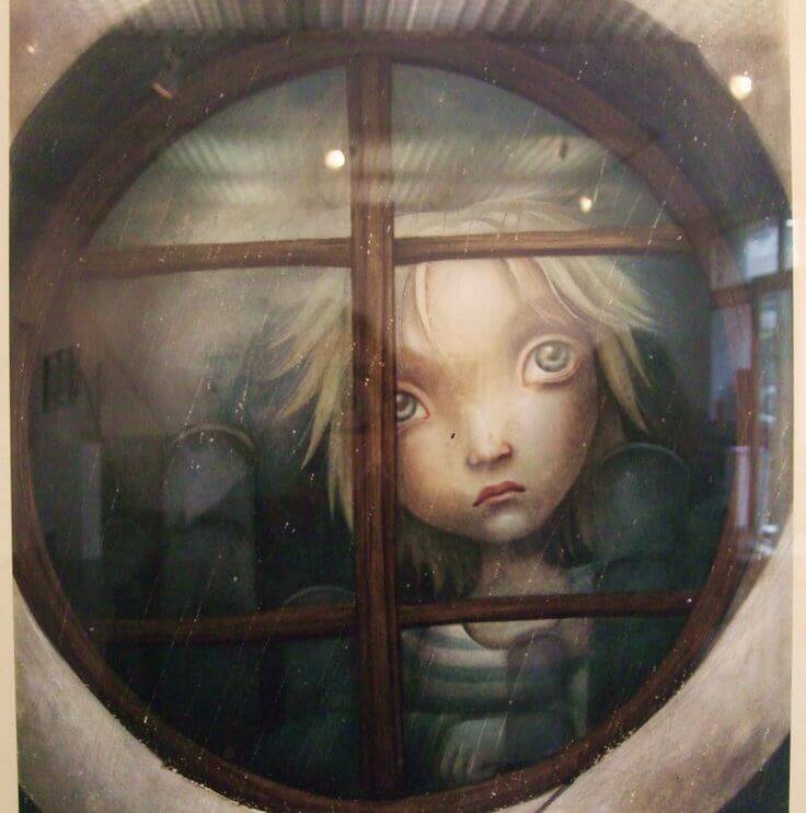 bambino triste alla finestra