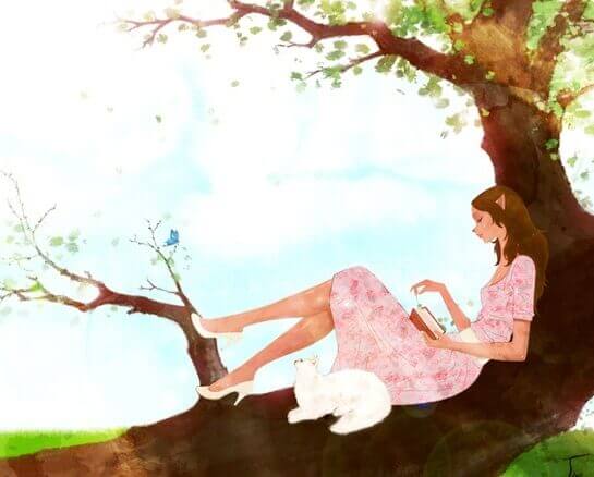 gatto bianco e ragazza che legge sull'albero