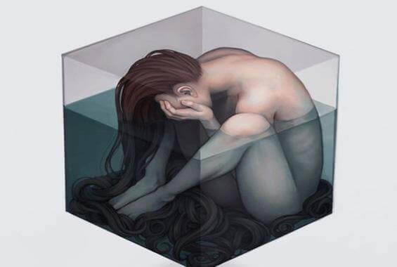 donna triste in un cubo