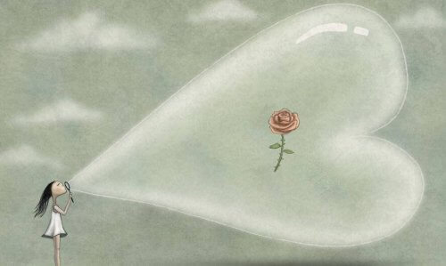 bambina che soffia palloncino a forma di cuore con dentro una rosa