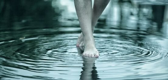piedi che camminano in acqua