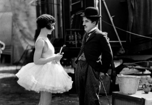 Charlie Chaplin mentre sorride con un'attrice