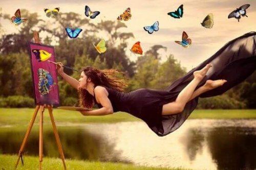 Donna che dipinge volando e farfalle