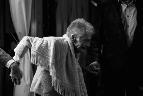 Uomini che aiutano una donna anziana