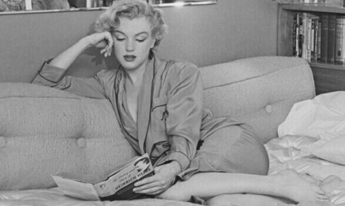Marilyn Monroe che legge una rivista
