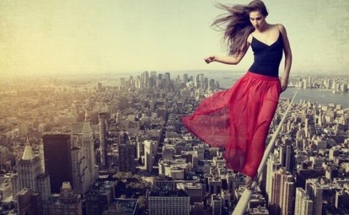 Donna che cammina su corda sopra alla città