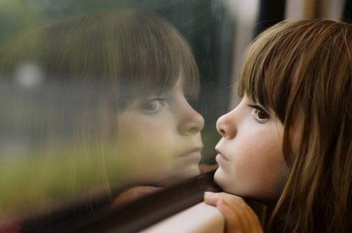 Bambina che guarda da una finestra