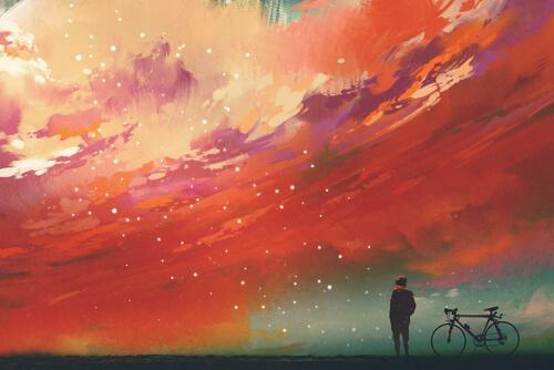 Uomo in bicicletta guarda cielo colorato
