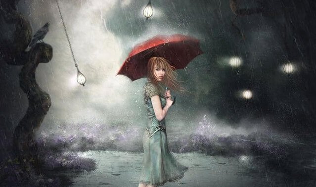 Donna sotto la pioggia con ombrello rosso