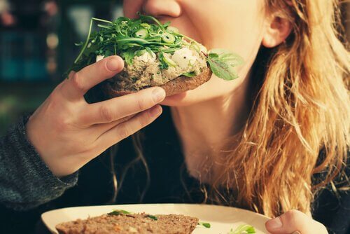 Teorie della fame e ragazza che mangia un panino