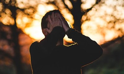 Uomo che si copre il volto