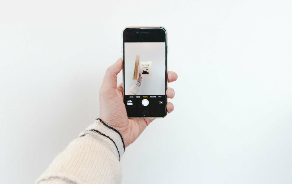 Mano che tiene cellulare.