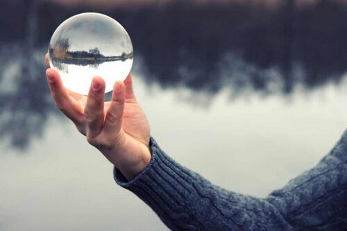 Uomo con una sfera di cristallo e agilita emotiva.